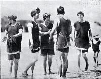 A group of young bathers in bathing costumes in the surf at Sumner beach on the Anniversary Day of Christchurch