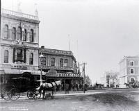 A hackney at the intersection of Cashel & High Streets with Milner & Thompson's music store on the right & Inglis' building on the left