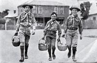 Cheerful Boy Scouts acting as messengers to distribute food and medicine to patients at their houses