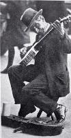 Busker with a banjo entertaining in Cathedral Square, Christchurch, ca 1927