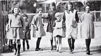 Photograph of Girls merrily on their way to Phillipstown School on the day Christchurch schools reopened after five months due to the removal of restrictions on the assembly of children after the end of the infantile paralysis epidemic.[1925]]