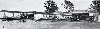 The New Zealand air arm of defence : Avro 504K aeroplanes lined up outside hangers. 1926