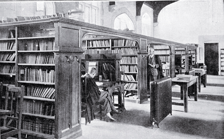 In the Canterbury College Library : the Acting Librarian, Mr Hardie, is seen facing the camera.