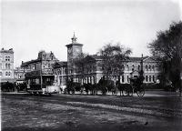 Horse-drawn trams, hackney & hansom cabs in front of the Godley Statue, Cathedral Square, Christchurch : the Post Office is behind.