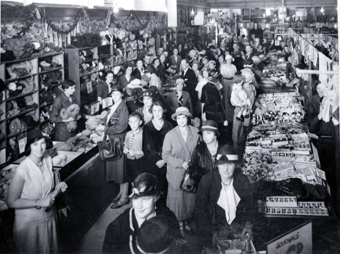 Interior view, shoppers in T. Armstrong & Co. store 