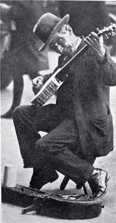 A busker with a banjo entertaining in Cathedral Square, Christchurch 