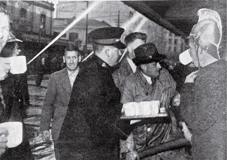 A Salvation Army worker provides tea for firemen and volunteers battling the fire 