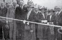 Mrs Ell cutting the ribbon at the opening of the Summit Road by the Minister of Public Works, the Hon. R. Semple 