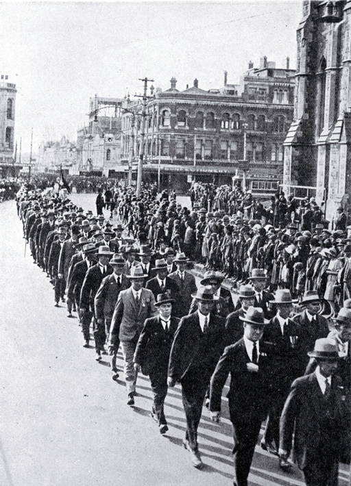 Returned soldiers in mufti and wearing medals marching past the Cathedral, Christchurch 