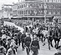 The gun carriage and firing party follow the wreath bearers, Christchurch 