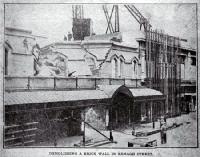 Demolishing a brick wall, T. Armstrong & Co. premises, corner of Colombo and Armagh Streets 