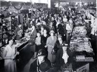 Interior view, shoppers in T. Armstrong & Co. store 