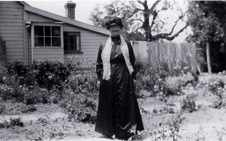 Amelia Frances Rogers (1849-1928) beside her riverside home at 348 New Brighton Road 