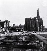 Rear of the Cathedral taken from the cleared site of the Tramway offices (now Government Buildings), Christchurch : at left is the Dalgety building.