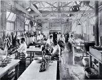 A small goods factory in Cashel Street, Christchurch : employees of the Christchurch Meat Co. Ltd. dicing meat and making sausages.