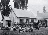 Outside the polling booth, Kaiapoi : people awaiting the results of the Southern Maori Electorate, 1902 Maori election.