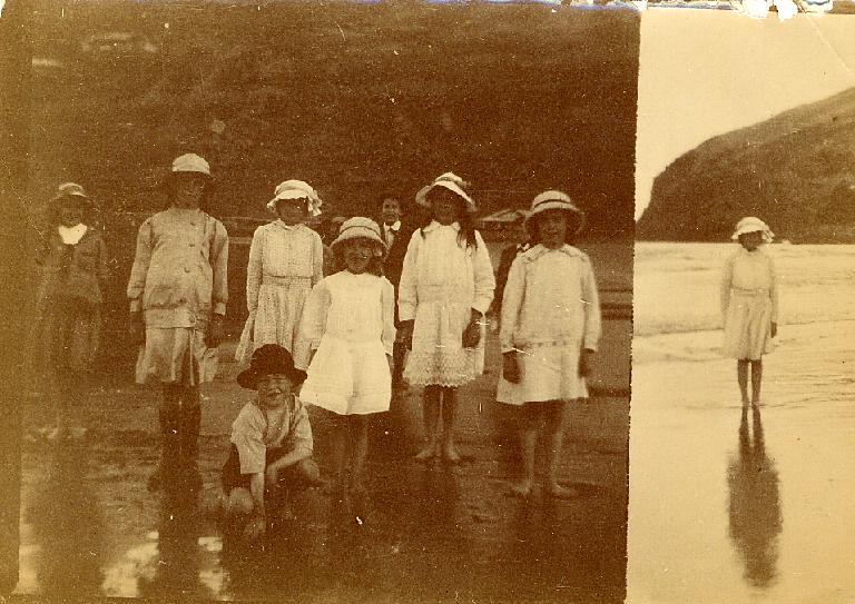 Group of children at the beach, Single child standing on beach
