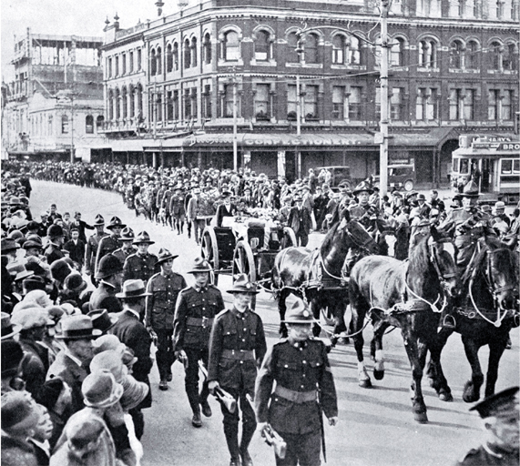 The gun carriage and firing party follow the wreath bearers, Christchurch 