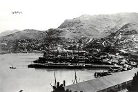 Lyttelton Harbour with ships at dock and tugboat on the water