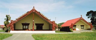 Aoraki (wharenui) on the left and Te Ari Taua (whare wananga) on the right.