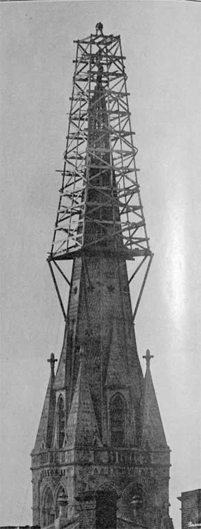 A risky position : making ready to place the cross on the summit of Christchurch Cathedral spire.