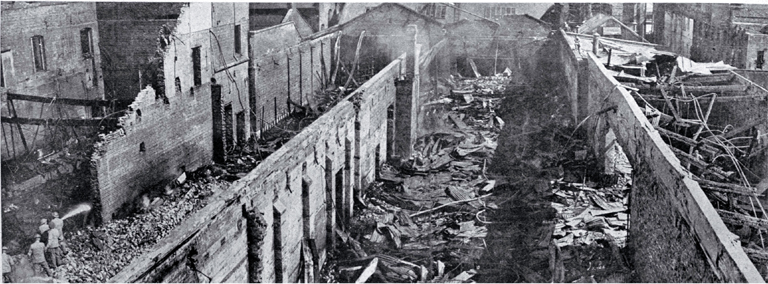 View of the central area of the gutted building : little remains except for the brick dividing walls and twisted roof iron.
