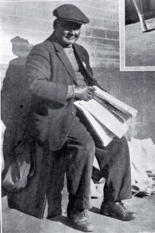 A newspaper vendor in Cathedral Square, Christchurch 