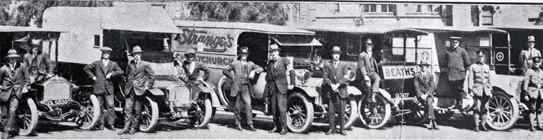 Some members of the St John Ambulance Brigade with the vehicles used as ambulances during the influenza epidemic 