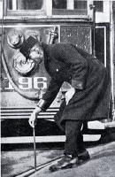 A tram conductor changes the points of the tram rails with a point bar 