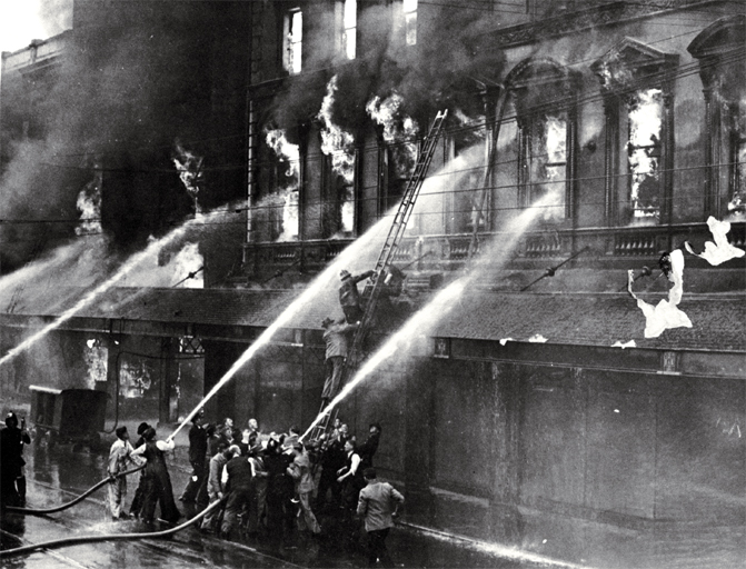 Rescuing Mr K. Ballantyne from the burning building on Colombo Street, Christchurch Rescuing Mr K. Ballantyne from the burning building on Colombo Street, Christchurch