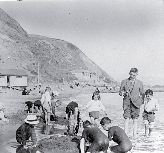 Children building sandcastles on the beach, possibly Wellington Children building sandcastles on the beach, possibly Wellington