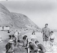 Children building sandcastles on the beach, possibly Wellington 