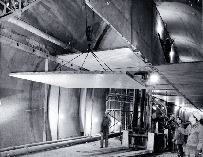 Ceiling panels being lifted into place during the construction of the Christchurch-Lyttelton Road Tunnel 