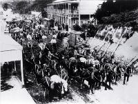 Wagons and horse teams hauling coal through Brunnerton on the West Coast 