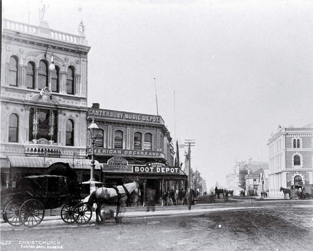 A hackney at the intersection of Cashel & High Streets : with Milner & Thompson's music store on the right & Inglis' building on the left. A hackney at the intersection of Cashel & High Streets : with Milner & Thompson's music store on the right & Inglis' building on the left.