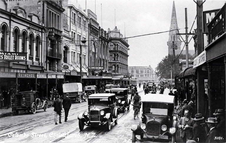 Cars, cyclists and pedestrians in Colombo Street, Christchurch : Cathedral Square is in the background.