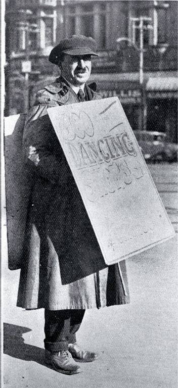 A sandwich-board man advertising dancing shoes in Cathedral Square, Christchurch 