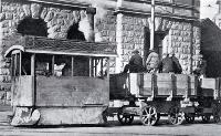 A Kitson steam tram runs past the Government Buildings in Cathedral Square with tramways workers on board 